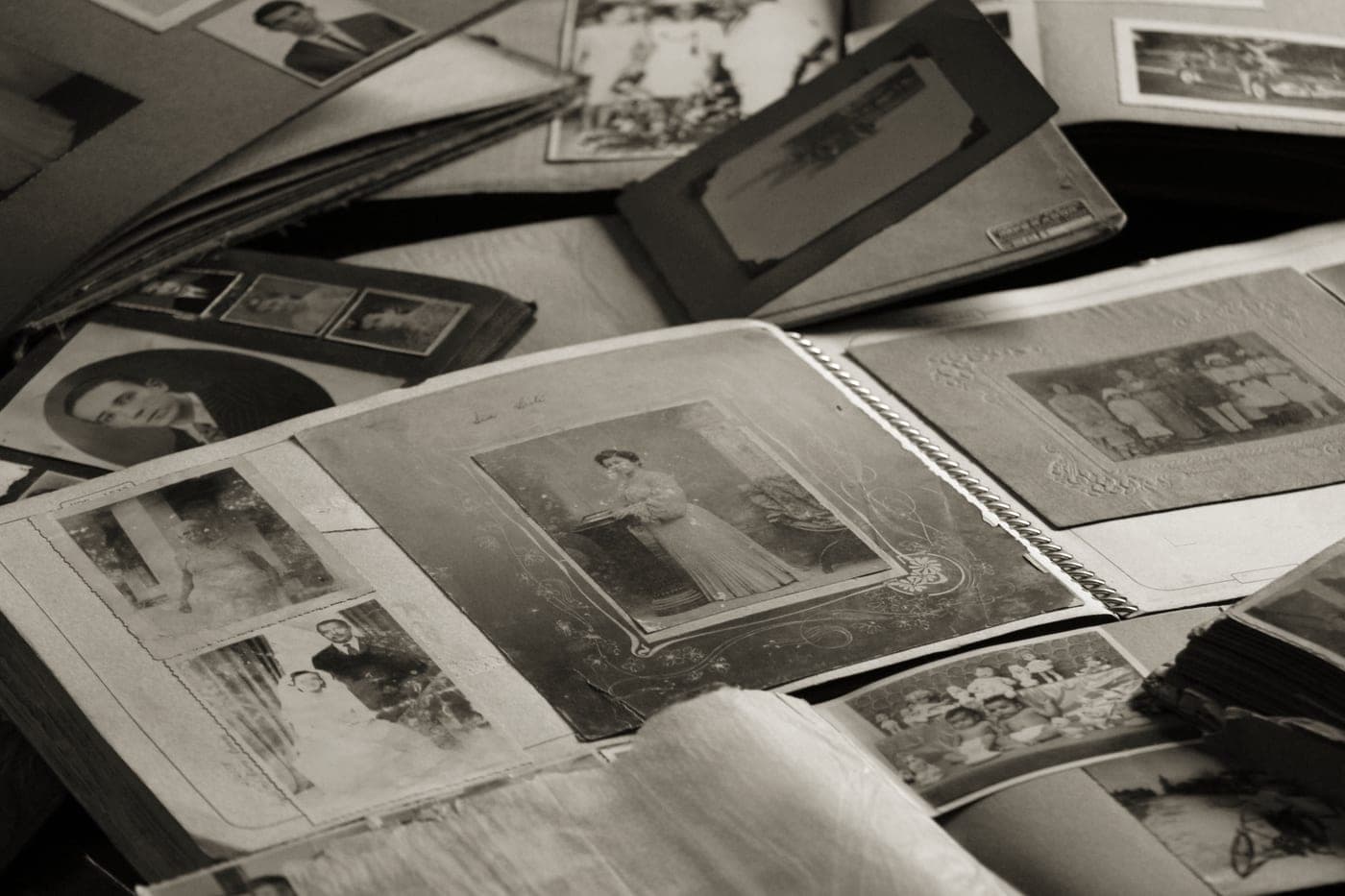 An open photo album with instant prints slotted into pocket pages