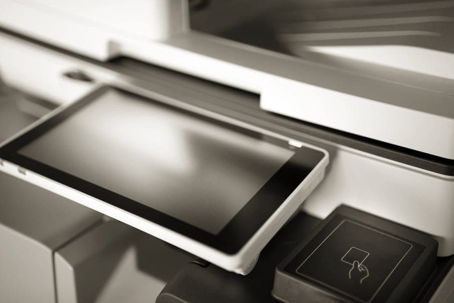 A small pocket photo printer producing a credit-card-size print
