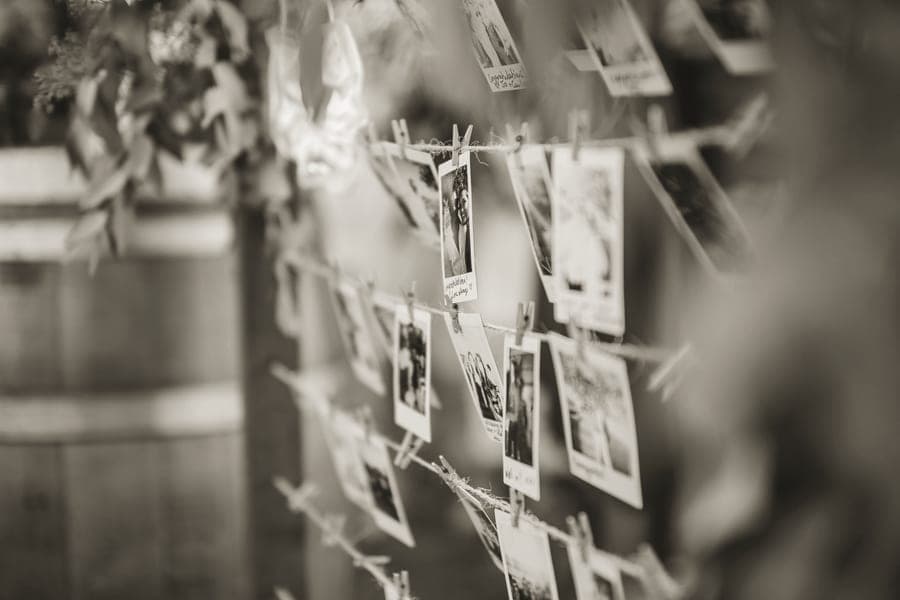 Instant prints pegged to a length of twine against a plain wall
