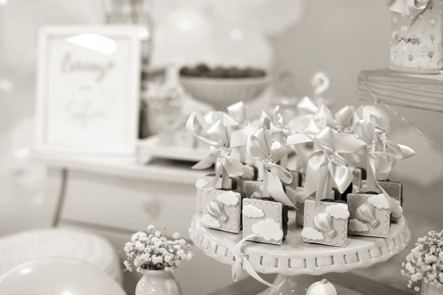 A baby shower table with decorations and a photo book