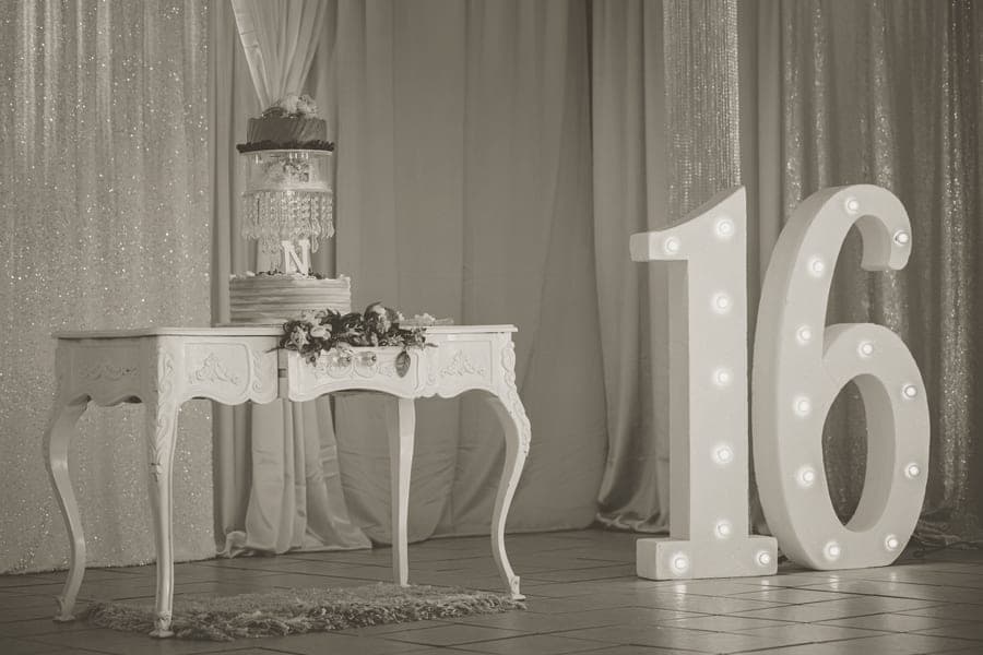 A birthday party table with decorations and photographs