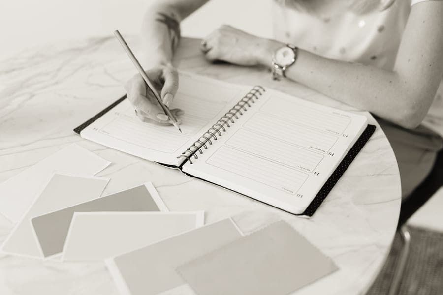 A notebook with film quantities worked out, beside film packs