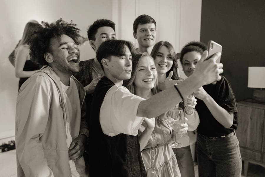A group of friends taking a photograph together at a party